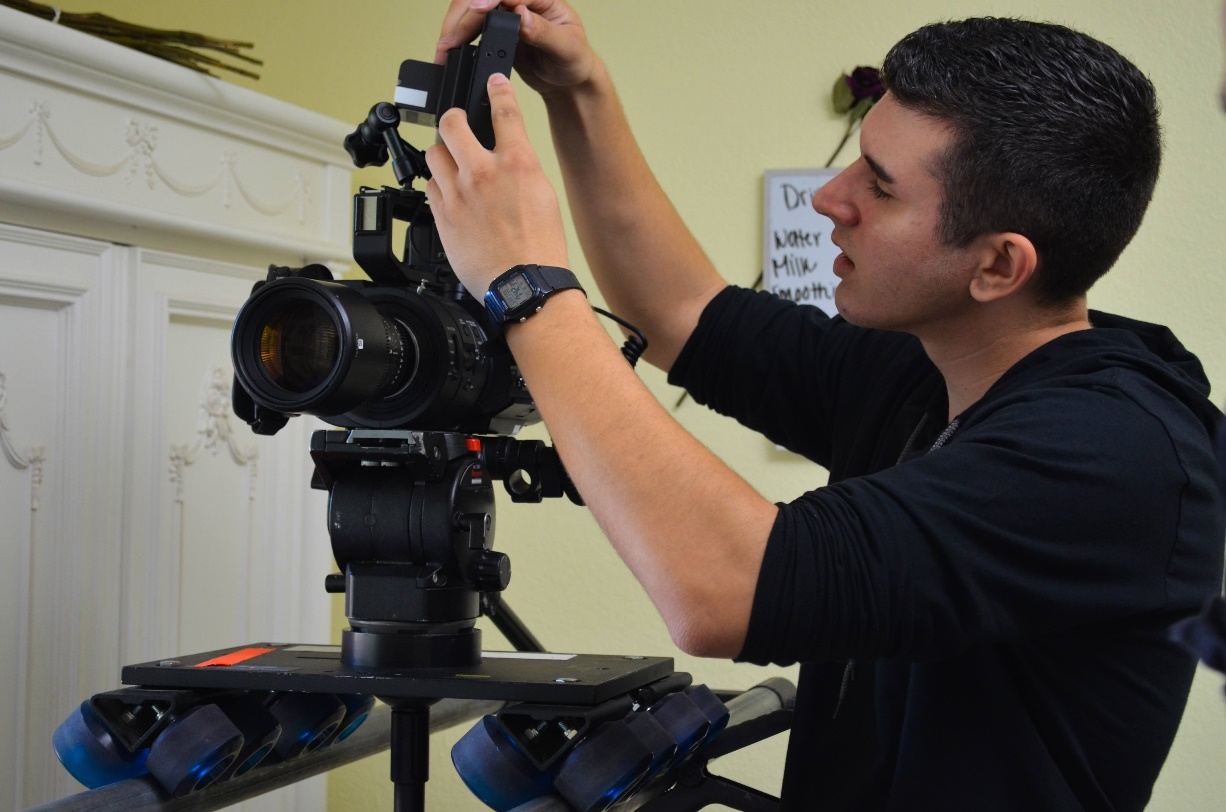 A man setting up a camera before a shoot